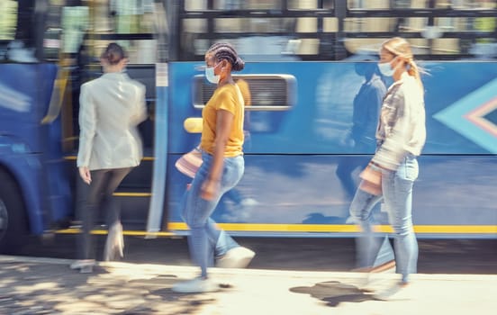 Women, covid travel and bus stop in city morning commute, public transportation or local travelling in motion blur. Diversity, passenger and covid 19 face mask in vehicle healthcare safety compliance.