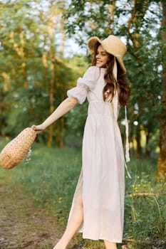 a cheerful woman with a basket in her hands walks through the woods enjoying a day off. High quality photo