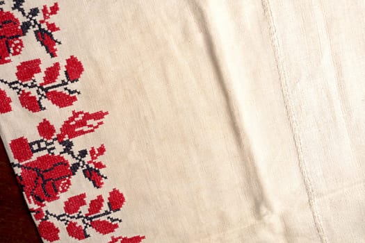 Woven linen cloth pattern background. Embroidered good like old handmade cross-stitch ethnic Ukraine pattern. Ukrainian rushnyk . Red version over white background. Line striped closeup weave fabric for kitchen towel material.
