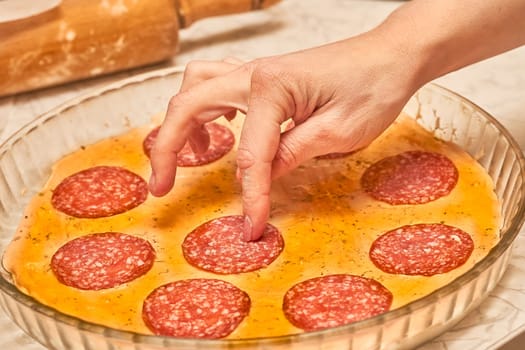 a dish of Italian origin consisting of a flat, round base of dough baked with a topping of tomato sauce and cheese, typically with added meat or vegetables