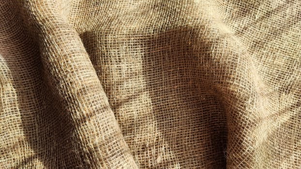 Natural fabric texture, frame and background of burlap. Rough crumpled burlap background. Selective focus