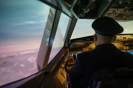 A man is studying to be a pilot in an aircraft simulator