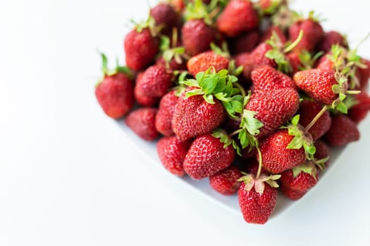 Ripe picked strawberries on the table. Collection of fresh organic strawberries. Delicious and sweet berry