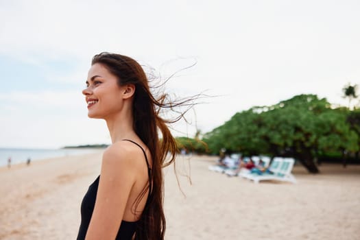 woman travel sea beach sand smile leisure lifestyle summer copy-space happy vacation sun young girl walk space copy nature bag beautiful ocean