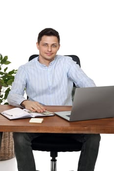 young man using laptop computer for online work at table on white background
