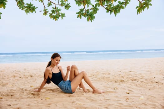 outdoor woman vacation white ocean freedom hair young sea sitting holiday hair relax nature tan beach carefree attractive travel smile long sand