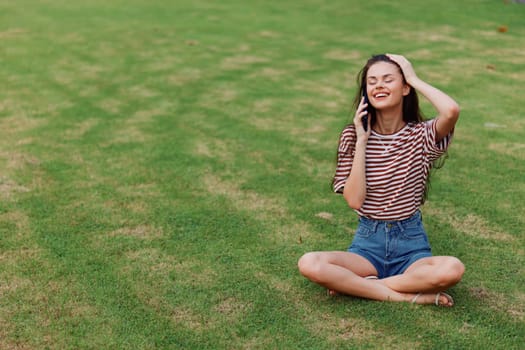 woman human blogger grass seasonal happy app park green smiling smartphone lifestyle smile palm phone nature young cellphone using working tree girl