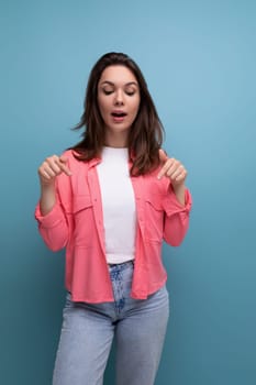 bright stylish brunette young woman in a fashionable shirt, t-shirt and jeans.