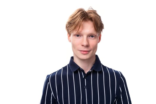 portrait of a pretty young blond guy in a striped polo shirt on a white background.
