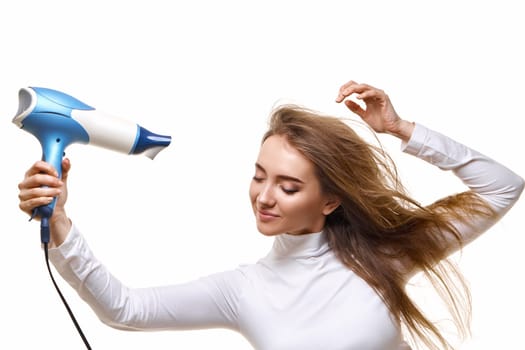 attractive cheerful lady drying long hair isolated on white background