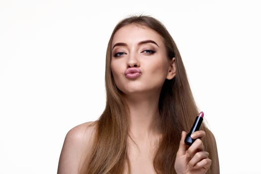 young funny girl using trendy pink lipstick isolated on white background