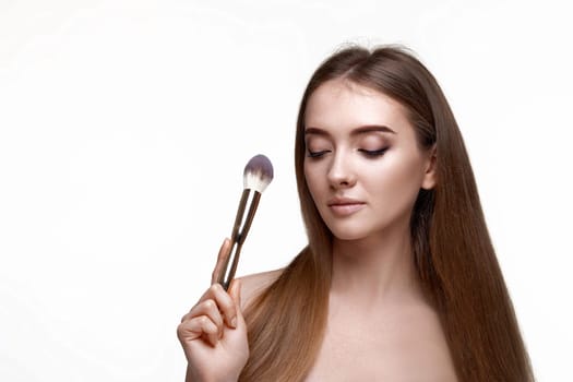 attractive woman with make-up brush for powder isolated on white background