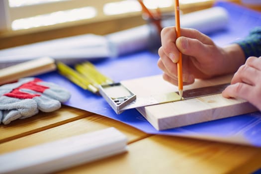 Architect working on drawing table in office.