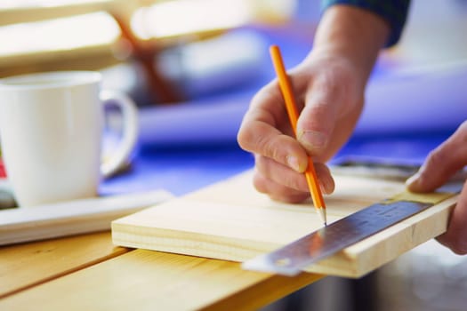 Architect working on drawing table in office.