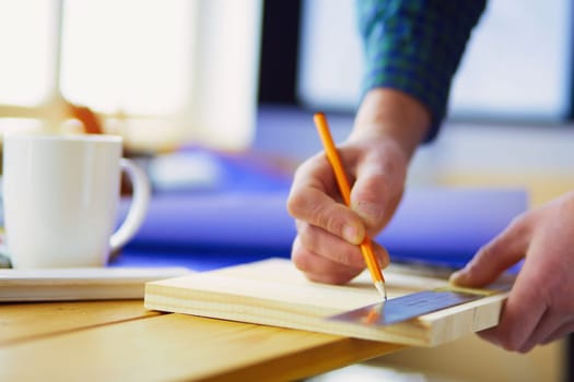 Architect working on drawing table in office.