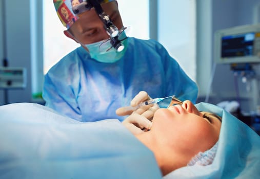 Man surgeon at work in operating room.