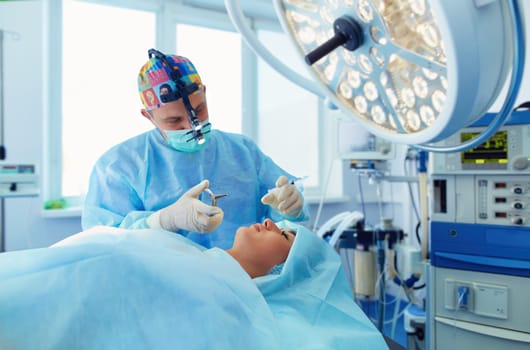 Man surgeon at work in operating room.