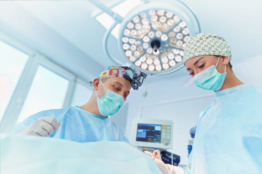 Team surgeon at work in operating room.