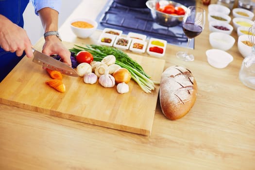 Man preparing delicious and healthy food in the home kitchen.