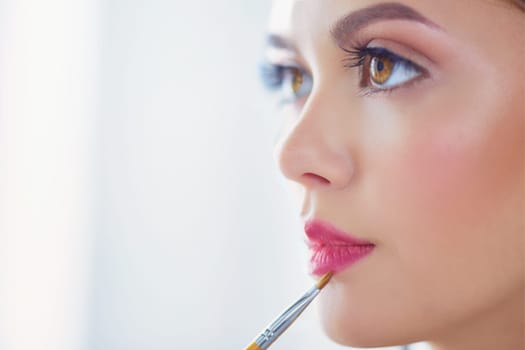 Beautiful girl with cosmetic powder brush for make up. Makeup. Make-up applying for perfect skin.