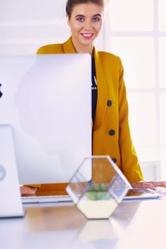 Portrait of a beautiful business woman standing near her workplace
