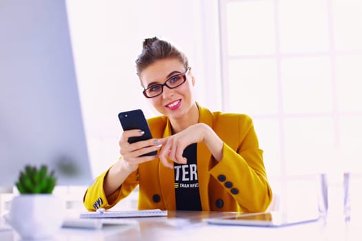 Attractive young woman checking her text messages on her mobile phone