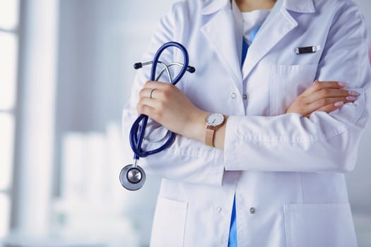 Smiling medical doctor woman with stethoscope in hospital.