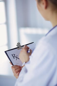 Female doctor holds blank prescription document. office Hospital.