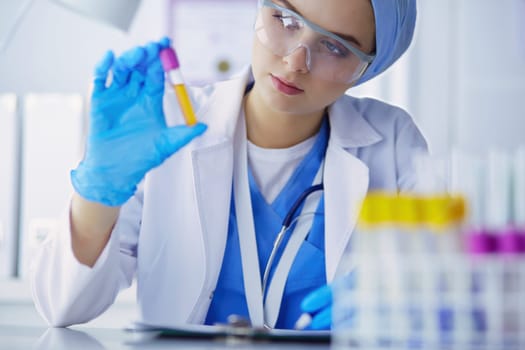 Laboratory assistant woman analyzing a blood sample.