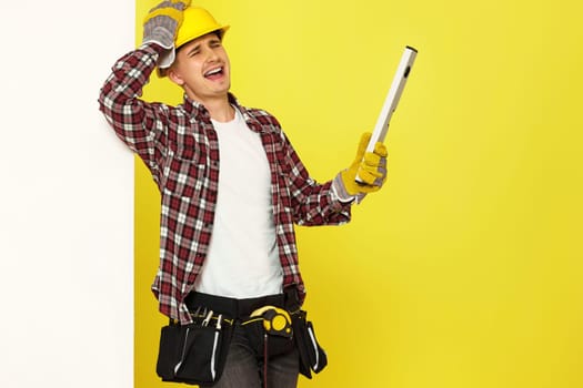 upset professional builder in work clothes in helmet with level . copy space for text