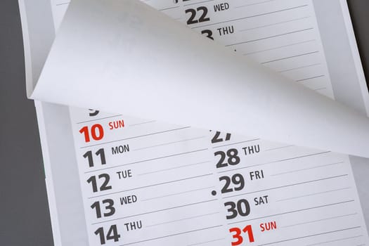 Close up of a paper calendar on grey background.