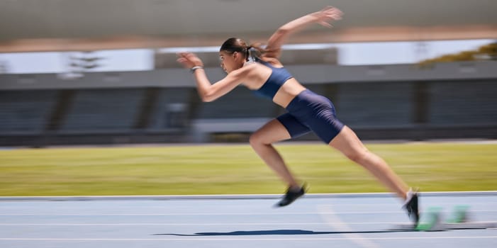 Athlete, running and sports track with a woman outdoor for fitness, exercise and training for a race, marathon or competition. Runner moving fast with speed and energy during workout for performance.