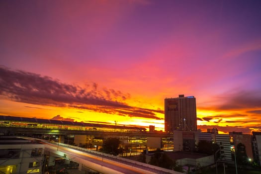A beautiful and dramatic panoramic photograph of city skyline, taken on a golden evening after sunset.