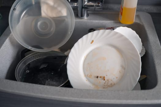A lot of dirty utensil on the kitchen