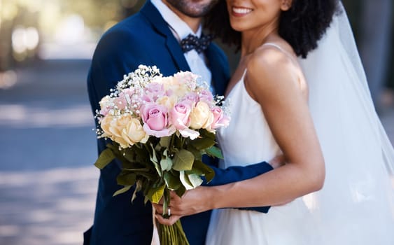 Flowers, wedding and marriage with a bride and groom posing outdoor for a photograph at their celebration event or ceremony. Rose bouquet, love and romance with a newlywed black couple outside.