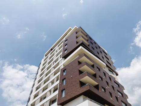 Modern high-rise hotel building with rectangular terraces against the sky. Budva, Montenegro. High quality photo