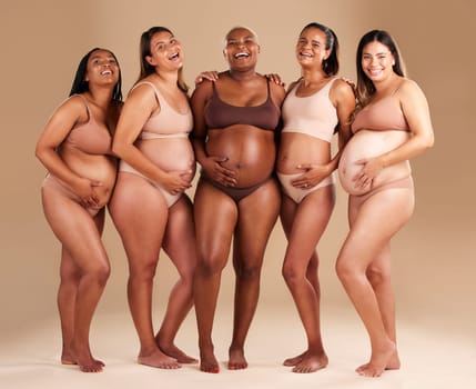 Pregnancy, body and portrait of happy friends in a studio for diversity, motherhood and prenatal wellness. Maternity, beauty and pregnant women showing baby bump stomach together by beige background