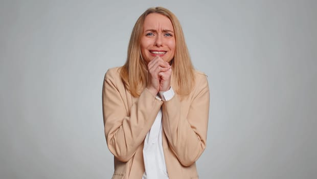 Scared fearful businesswoman terrified about danger problems, suffering phobia, anxiety disorder, expresses fear, waving no, insecure, stress, panic. Female girl in suit. Woman on gray background