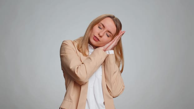 Tired business woman yawning, sleepy inattentive feeling somnolent lazy bored gaping suffering from lack of sleep. Adult girl isolated alone on gray studio background. Office people lifestyle concept