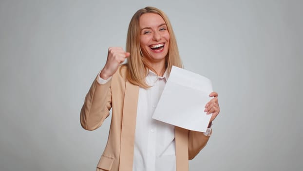 Business woman in formal suit open envelope take out letter reads it feel happy. Girl career growth advance promotion, bank loan approve, monetary award long-awaited invitation great news, lottery win
