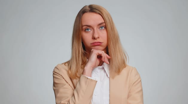 Sad business woman tired bored indifferent expression, exhausted of tedious story, not interested in communication talk, displeasure, uninteresting. Girl isolated indoor on gray studio background