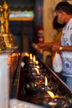 Tranquil Beauty: Candlelit Altar in a Traditional Thai Temple.