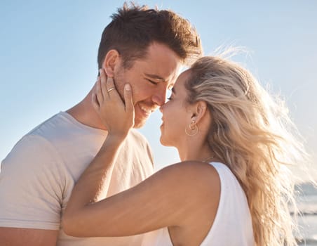 Love, couple and beach holiday, vacation or summer date and honeymoon outdoors. Affection, romance and smile of man and woman ready for kiss, having fun and enjoying quality time together at seashore.