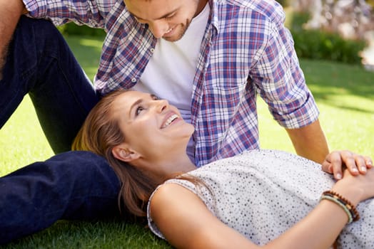 Bonding couple, lying and love on grass, nature park or garden on valentines day, romance date or marriage bonding. Smile, happy woman and man in relax environment, summer rest or partnership picnic.