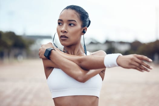 Black woman, fitness and stretching, exercise and earphones, music and motivation for active lifestyle outdoors. African American, strong and focus, cardio and endurance, workout and healthy living
