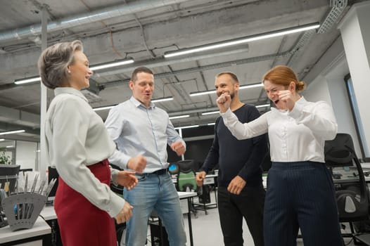 Four colleagues rejoice in success in the office