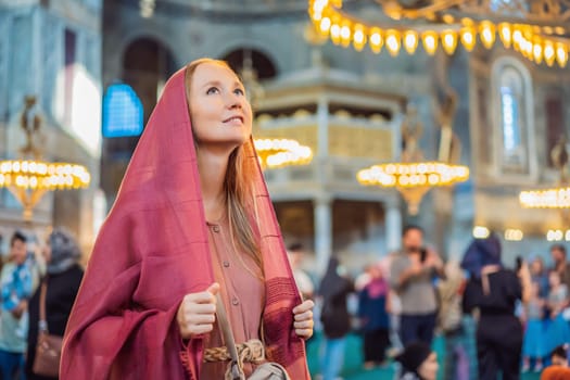 Woman tourist enjoying Hagia Sofia, Ayasofya interior in Istanbul, Turkey, Byzantine architecture, city landmark and architectural world wonder. Turkiye.