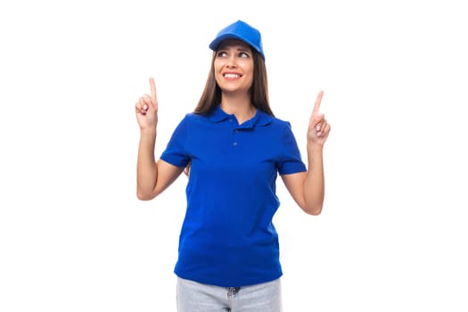 young caucasian brunette advertiser woman in blank blue t-shirt and cap showing thumbs up.