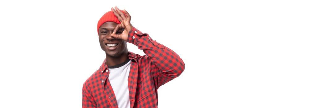 panoramic photo of a confident young ethnic african guy in a stylish look isolated on a white background.