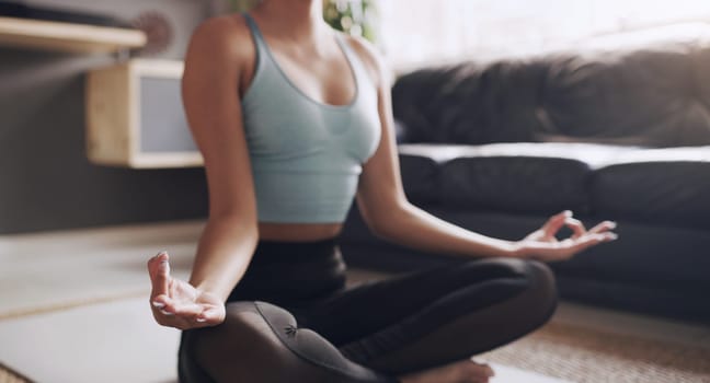 Yoga, lotus and hands of woman on living room floor for breath, exercise or zen in her home. Inner peace, meditation and female person relax while meditating for healing, balance or wellness training.